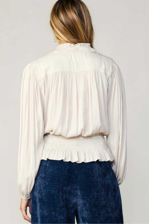 This Peplum Bell Sleeve Blouse with a ruffled hem takes Beige